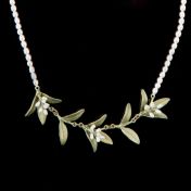 Diese bezaubernde Perlen-Halskette hat einen feinen, eleganten Myrte-Zweig als Anhänger. Der Zweig mit kleinen Blättern aus handpatinierter Bronze bildet die untere Biegung der Kette und hat drei kleine Blütentrauben aus Perlen. Handgefertigt in New York.